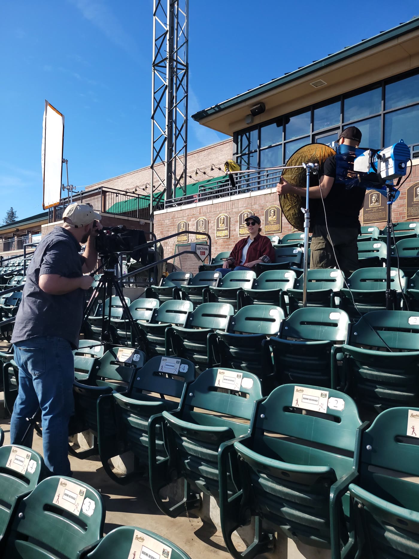 A film crew recording at the Visalia Rawhide ballpark